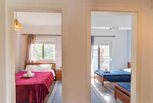 a bedroom with a bed with a red blanket at Erifili Kallithea in Kallithea Halkidikis