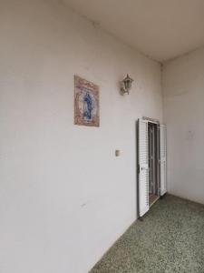 una camera bianca con una foto sul muro di Portas da Vila a Sesimbra