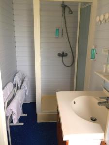 La salle de bains est pourvue de 3 serviettes, d'un lavabo et d'une baignoire. dans l'établissement Hôtel Mer et Forêt, à Saint-Trojan-les-Bains