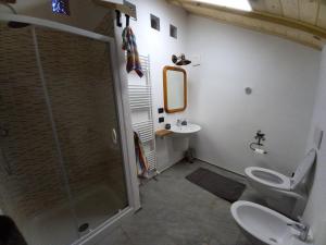 a bathroom with a shower and a toilet and a sink at SOLENEVE in San Domenico +5 photos