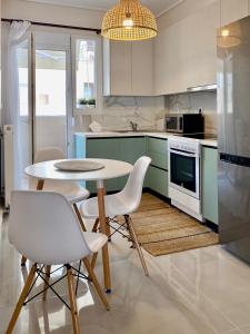 a kitchen with a table and chairs in a kitchen at East Coast Thessaloniki in Thessaloniki