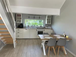 a kitchen with a table and chairs and a sink at Apartament Górska Fantazja in Ustroń