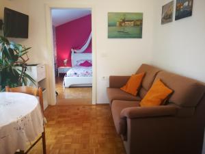 ein Wohnzimmer mit Sofa und ein Schlafzimmer in der Unterkunft MILLENCA Apartment in Izola