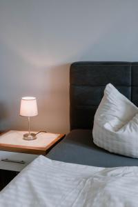 a bedroom with a bed and a lamp on a table at Ferienwohnung 2 in Dargen