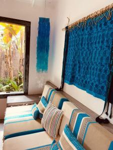 a couch sitting in a room with a window at Hotel Boutique Perainda in Trancoso