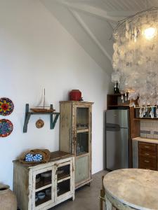 a kitchen with a refrigerator and a table at Hotel Boutique Perainda in Trancoso