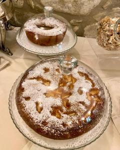 two cakes on two plates on a table at Relais Villa Baldelli in Cortona