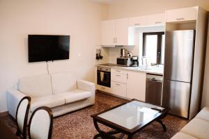 a living room with a couch and a table and a kitchen at Luxury Apartment in Plaka - Acropolis (Luisa) in Athens