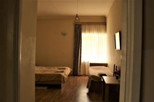Voodi või voodid majutusasutuse Taoskari Hotel toas