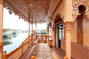 a balcony of a building next to a body of water at Houseboat Ambassador in Srinagar