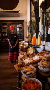 a woman standing in front of a buffet of food at Karongwe Portfolio - Kuname Lodge in Hoedspruit