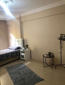 a bedroom with a bed and a table with a rug at A room which close to the centre of Istanbul , 10 minutes to metro in Istanbul