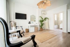 a living room with white walls and a ceiling at Sandal Alaçatı - Adult Only in Alacati