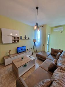 a living room with a couch and a coffee table at Donel Apartment in Durrës