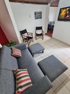 a living room with a gray couch and chairs at Depto confortable para 4 Personas in Posadas