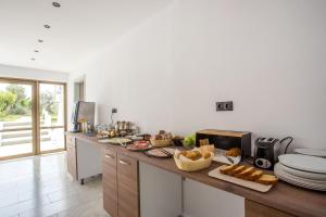 a kitchen with a counter with bread on it at Nikos BnB in Faliraki