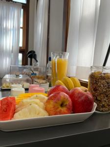 un plato de fruta en una mesa con un plato de frutos secos en Pousada dos Arcos en Ascurra