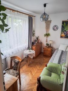 a bedroom with a bed and a couch and a window at Instytut Zdrowia i Hortiterapii in Mrągowo
