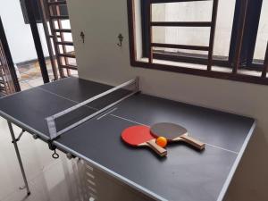 a ping pong table with a ping paddle and a racket at Mount Austin Corner Karaoke 24 pax with pool table in Johor Bahru