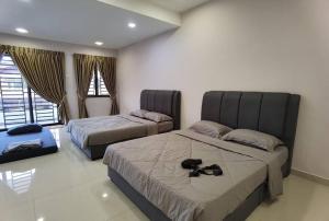 sypialnia z dwoma łóżkami z butami na nich w obiekcie Mount Austin Corner Karaoke 24 pax with pool table w mieście Johor Bahru