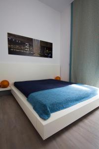 a bedroom with a bed with a blue blanket on it at Apartment 43 in Budapest