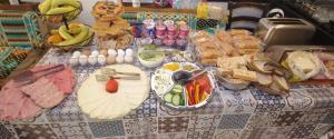 a table with food and eggs and other foods on it at The Exiles Hotel in Sliema