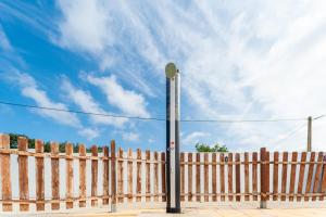 a light pole next to a wooden fence at Chalet Privado Rural Barbate in Barbate