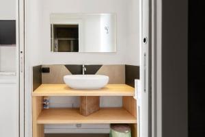 y baño con lavabo y espejo. en Sorres Home & Relax 10 min da Sassari Loft AC e WiFi, en Codrongianos