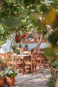 einen Tisch und Stühle in einem Garten mit Pflanzen in der Unterkunft Lemon Tree Apartments Samos in Votsalákia