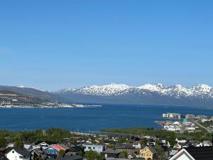 a view of a town with snow covered mountains at Apartment Tromsdalen. Tromsø in Tromsø