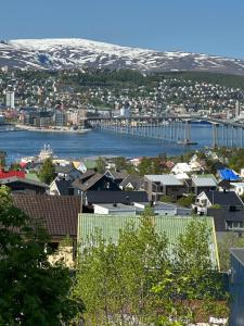 arial view of a city with a harbor and a bridge at Apartment Tromsdalen. Tromsø in Tromsø