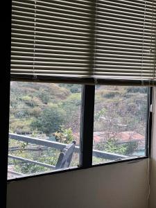 a window in a room with a view of a mountain at Crush Va Toi in Da Lat