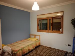a bedroom with a bed and a cabinet in it at شقة على النيل بالمعادي in Cairo