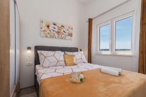 a bedroom with a bed and a window at Amazing sea view apartment- Romantica in Kastel Stafilic