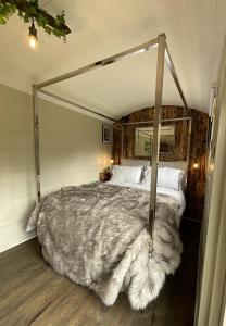 a bedroom with a large bed with a canopy at Gillan Creek Retreat in Helston