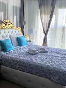 a large bed with blue pillows in a bedroom at Chrystal Boutique Suite in Skala Marion