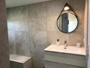 a bathroom with a sink and a mirror at Logis des vignes in Saint-Émilion