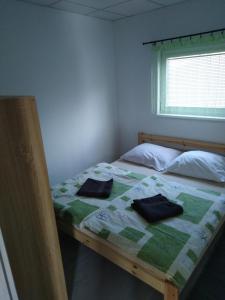 a bedroom with a bed with two pillows on it at Apartmány Vihorlat III in Kaluža