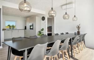 a dining room with a black table and chairs at Pet Friendly Home In Børkop With Wifi in Børkop