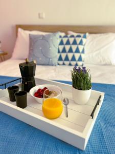a tray with fruits and vegetables on a bed at Down town villa Kavala in Kavala