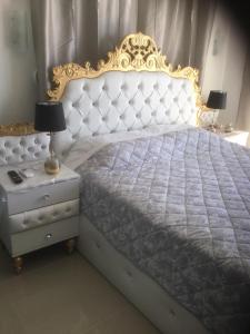 a bedroom with a bed with a gold frame and a nightstand at Chrystal Boutique Suite in Skala Marion