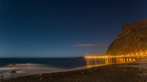 a view of a beach at night with a mountain at Apartamentos Charco del Conde in Valle Gran Rey