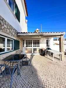 a patio with a table and chairs in front of a building at Venus House in Lamas