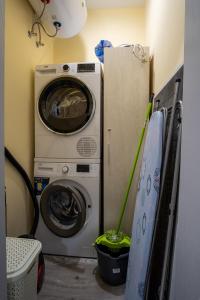 a laundry room with a washer and a washing machine at Apartment Yana in Ruse