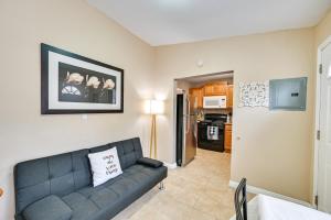 a living room with a couch and a kitchen at Inviting Poway Studio with Patio and Gas Grill! in Poway