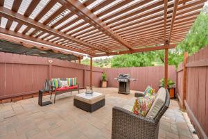 a patio with a wooden pergola and a grill at Inviting Poway Studio with Patio and Gas Grill! in Poway