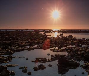 a sunset on the shore of the ocean at Apartamentos Charco del Conde in Valle Gran Rey