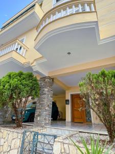 a house with a balcony and a front door at Down town villa Kavala in Kavala