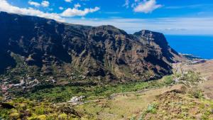 an aerial view of a mountain with the ocean at Apartamentos Charco del Conde in Valle Gran Rey
