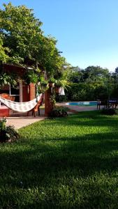 a hammock in the grass in a park at ALQUIMIA in Paso de la Patria